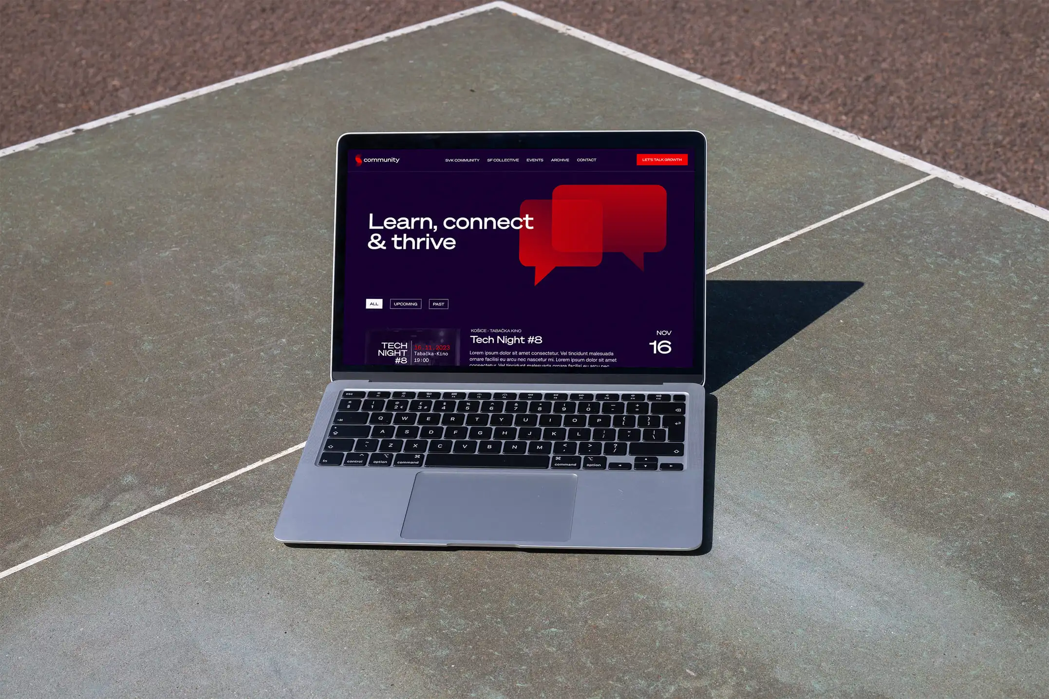 Macbook placed on the ground showcasing the web design of community project