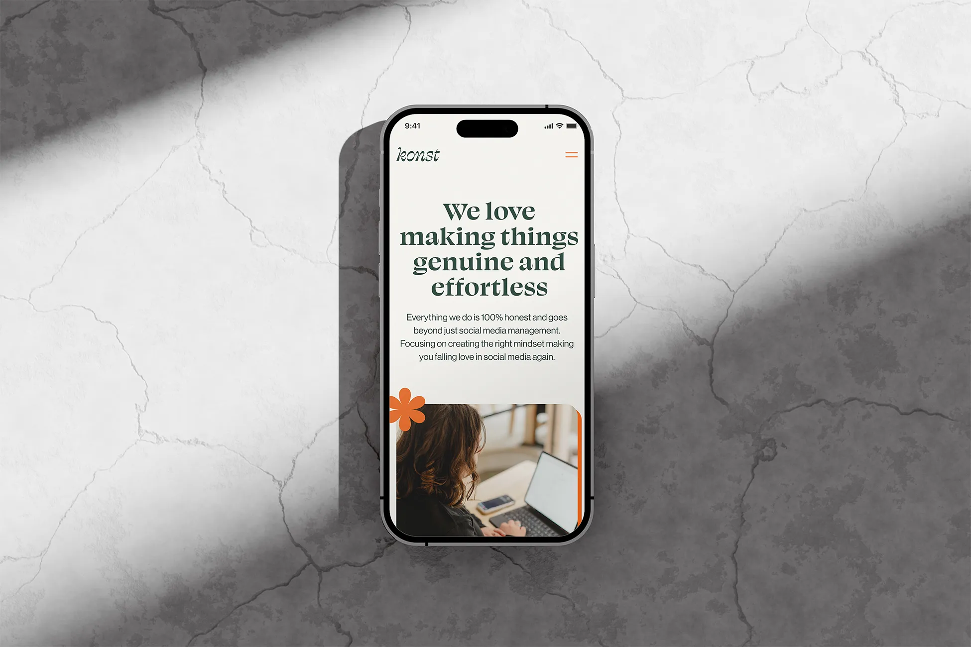 Iphone placed on a concrete surface showcasing the web design of Konst project