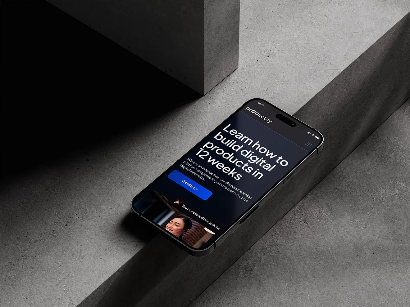 Iphone placed on a concrete stair showcasing the web design of Productify project