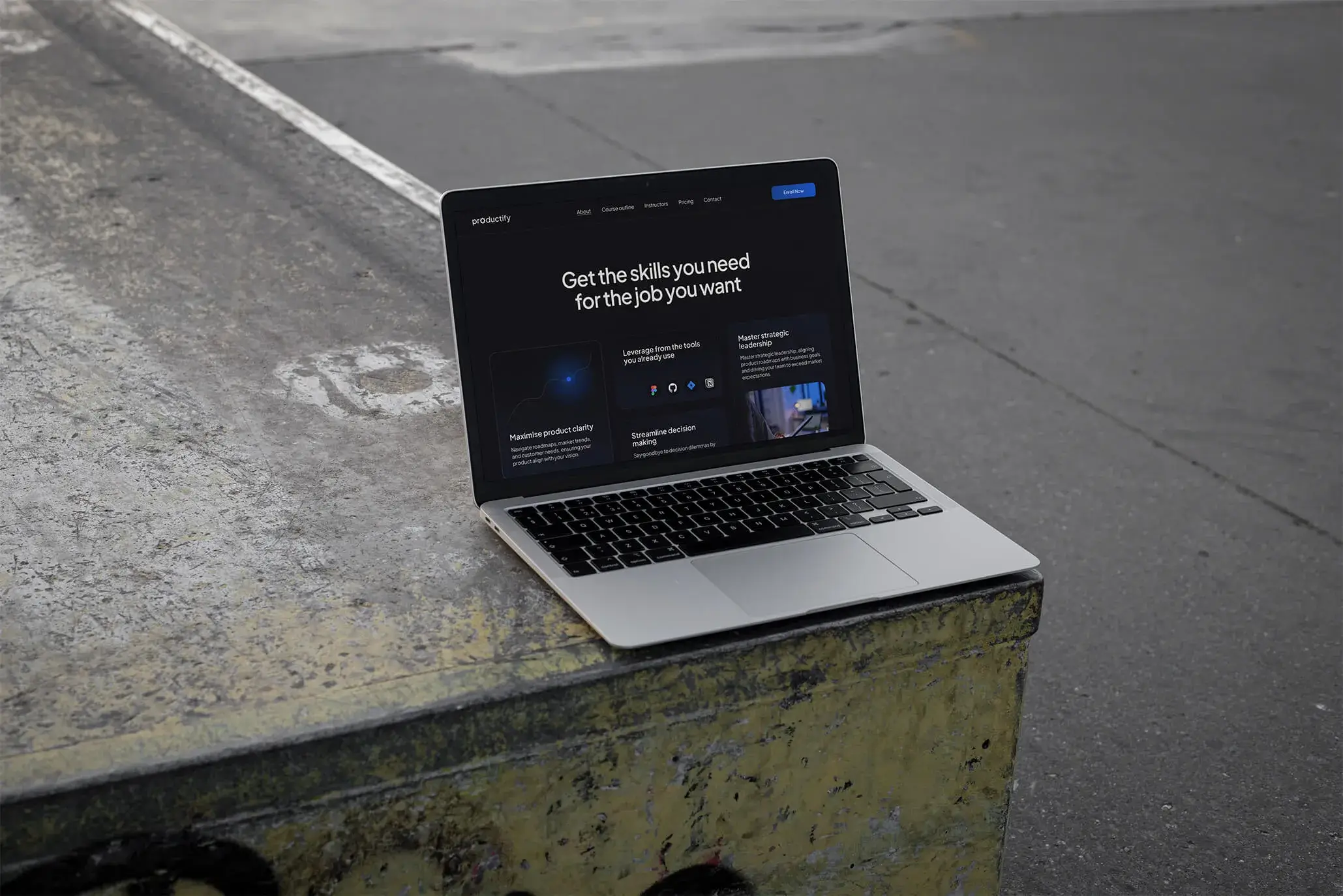 Laptop placed on a concerete surface showcasing a bento section of Productify project.