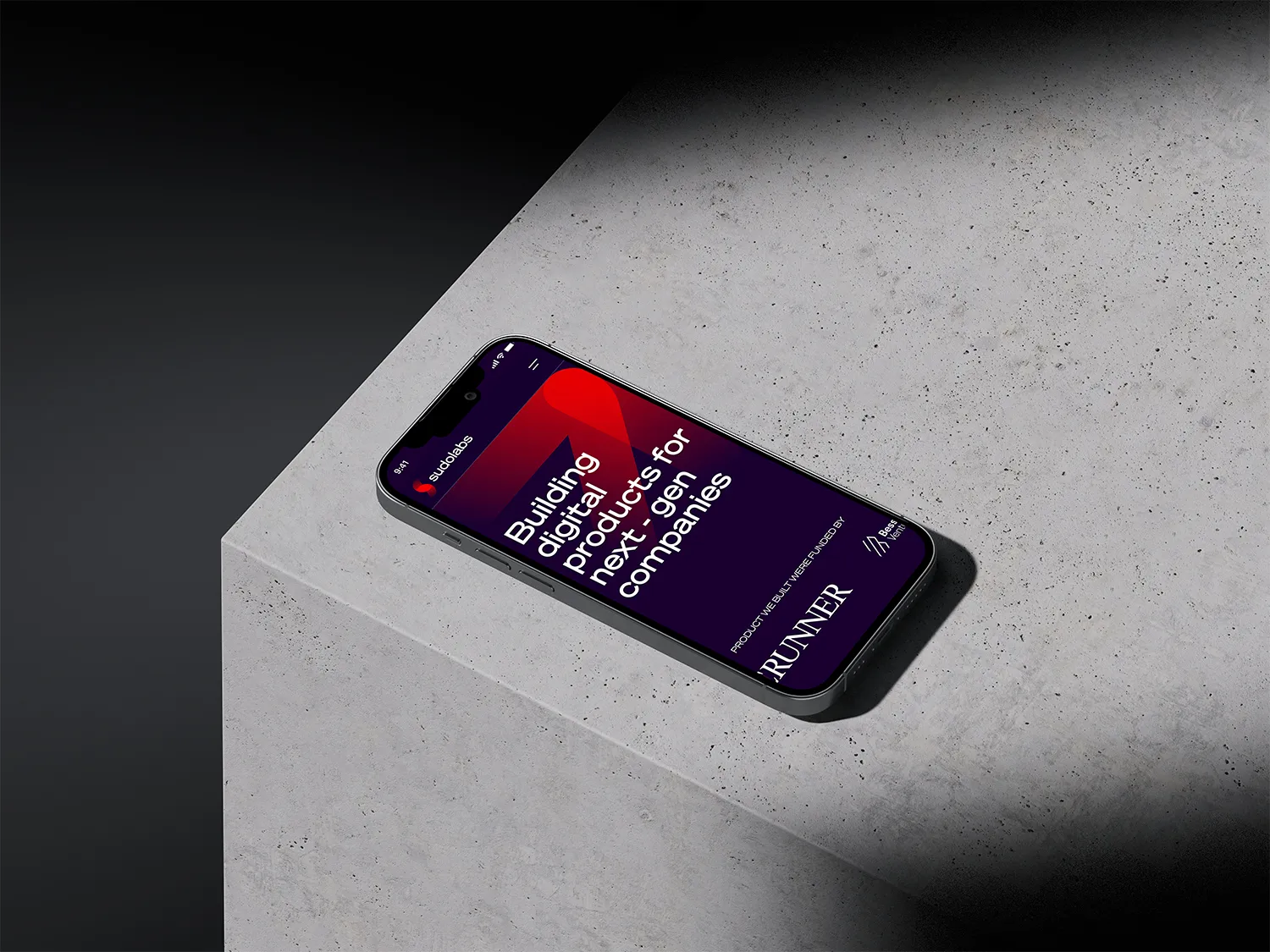 Iphone placed on a concrete surface showcasing the web design of Sudolabs project